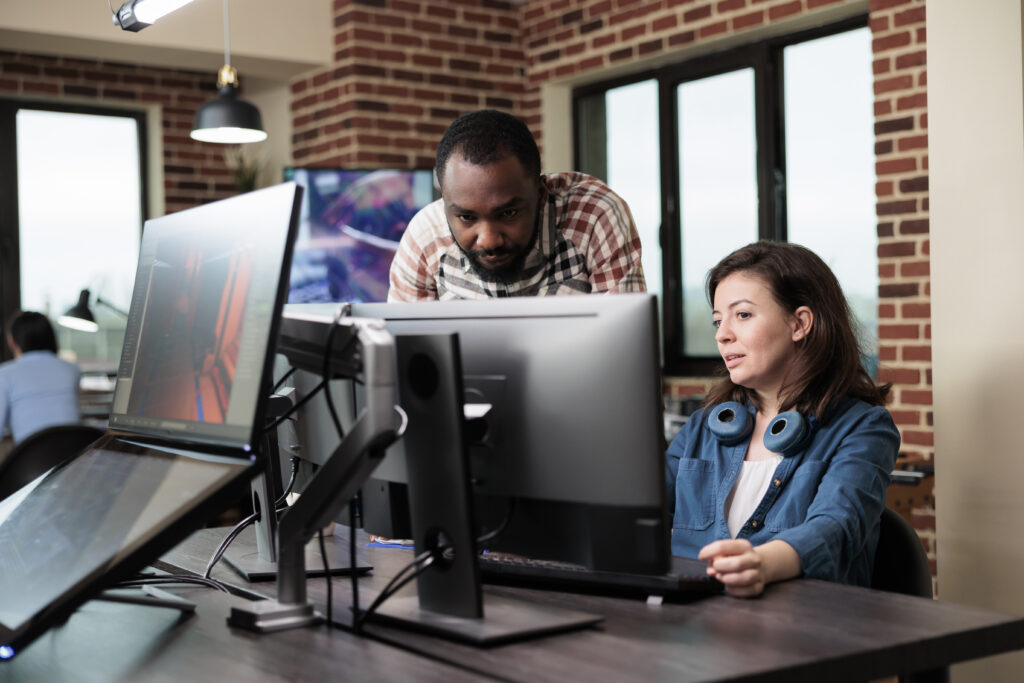 African american company coworker standing near production department team leader desk while discussing.