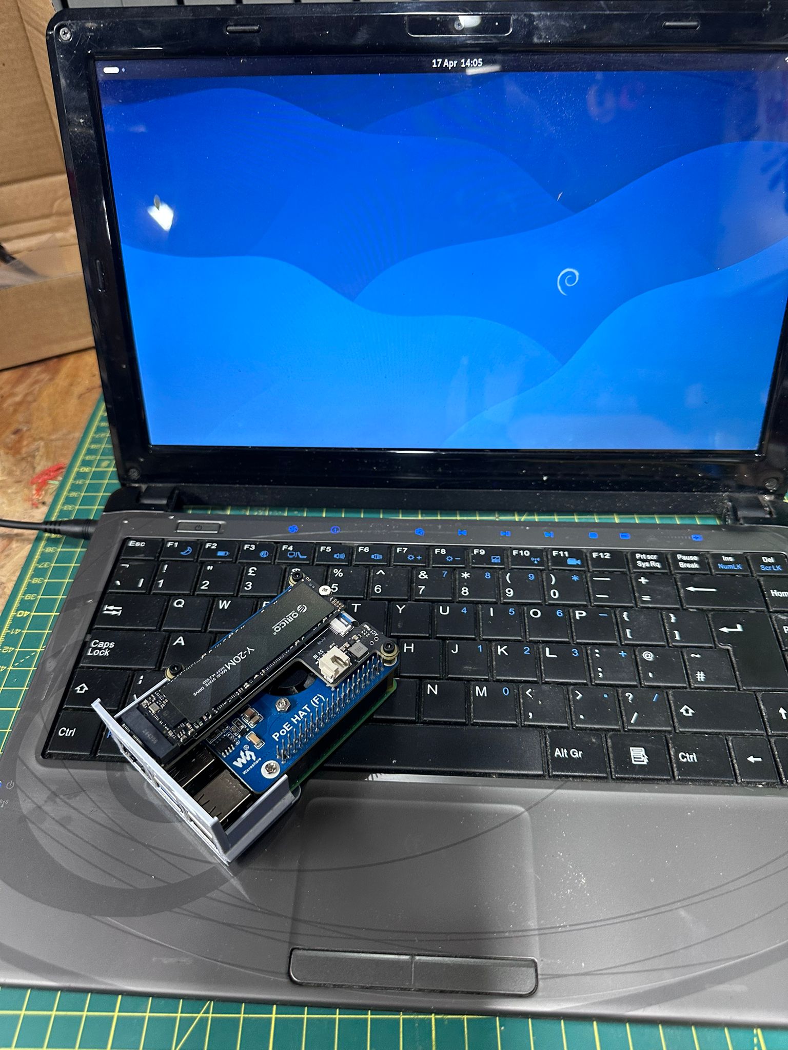 Advent Verona running Debian with a Raspberry Pi and display hat on the keyboard