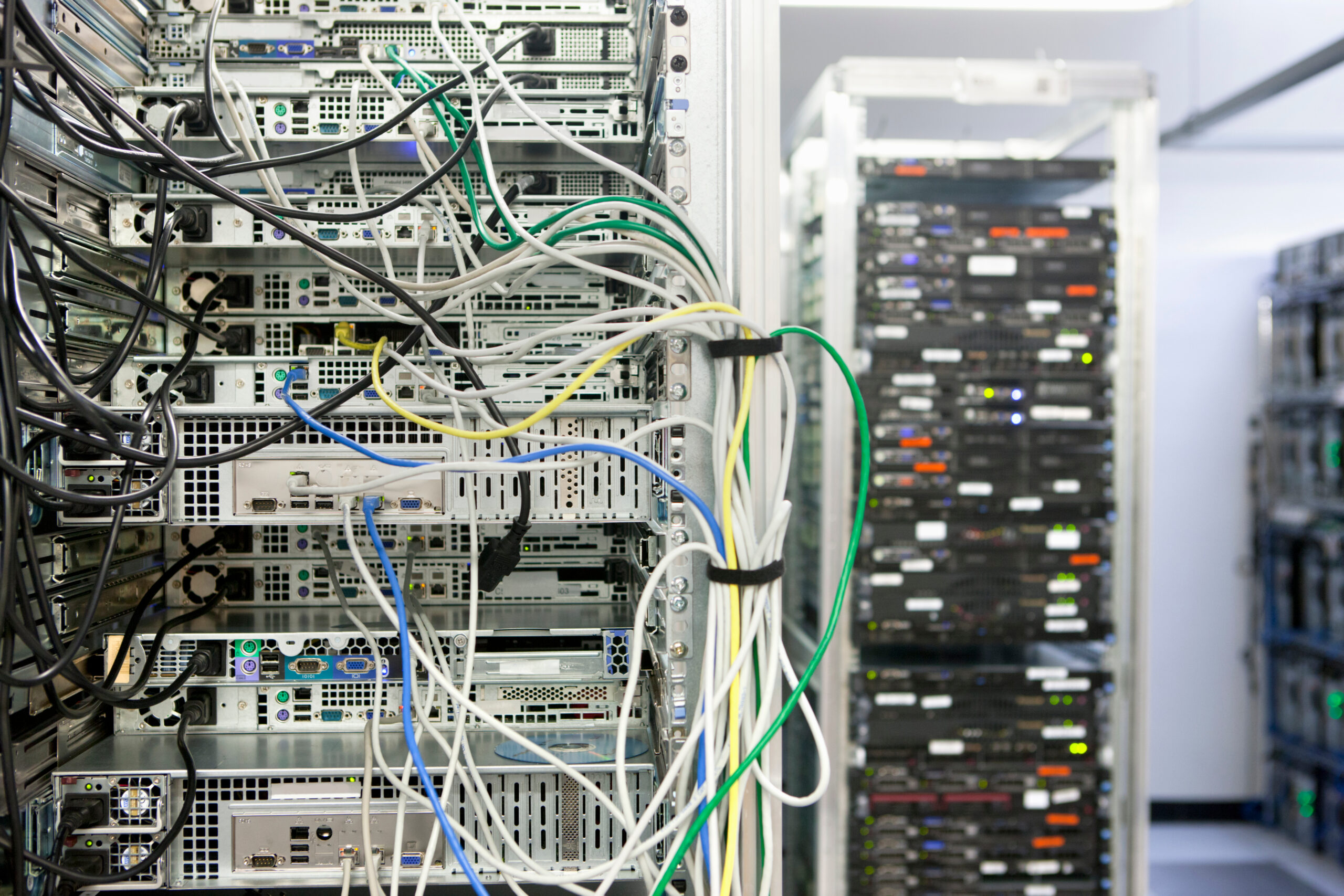 Close-up of the rear of a heavily populated server rack showing dense power and network cabling
