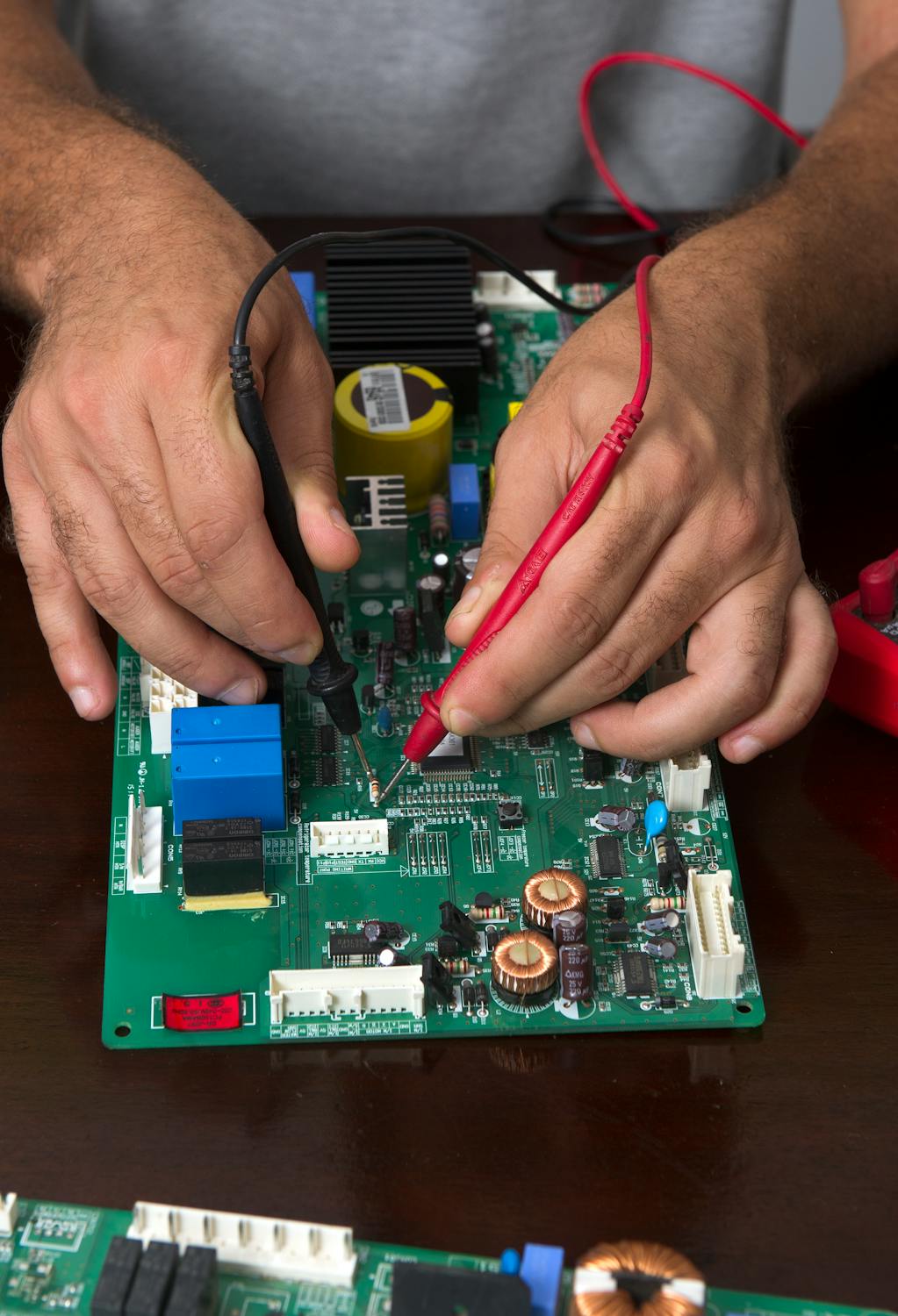 Hands working on a computer motherboard
