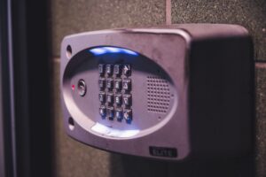 An illuminated security keypad mounted on a wall, representing deliberate access control