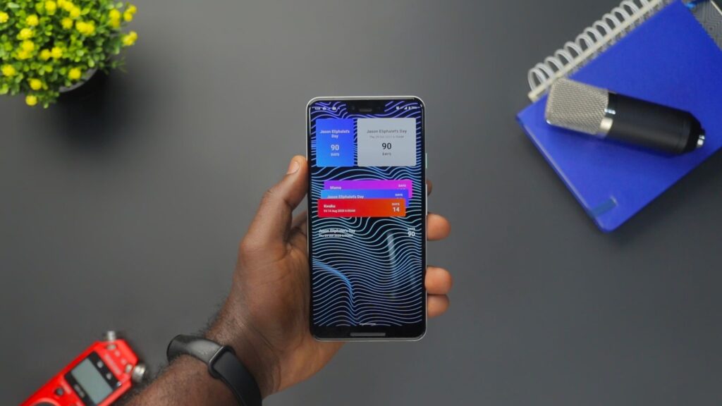 A hand holding a smartphone showing a heads-up notification