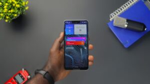 A hand holding a smartphone showing a heads-up notification