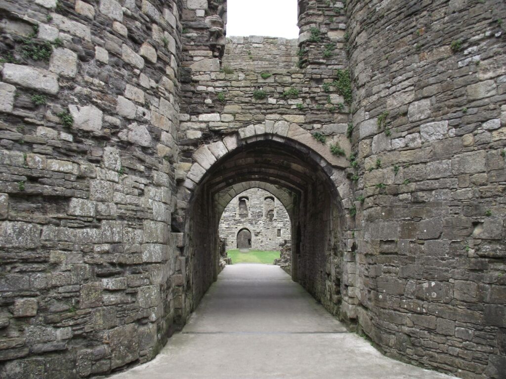 Medieval stone castle archway with an open corridor leading inside the walls