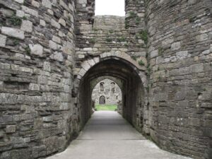 Medieval stone castle archway with an open corridor leading inside the walls